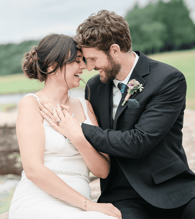 Romantic wedding portrait of a bride and groom outdoors, capturing love and happiness.