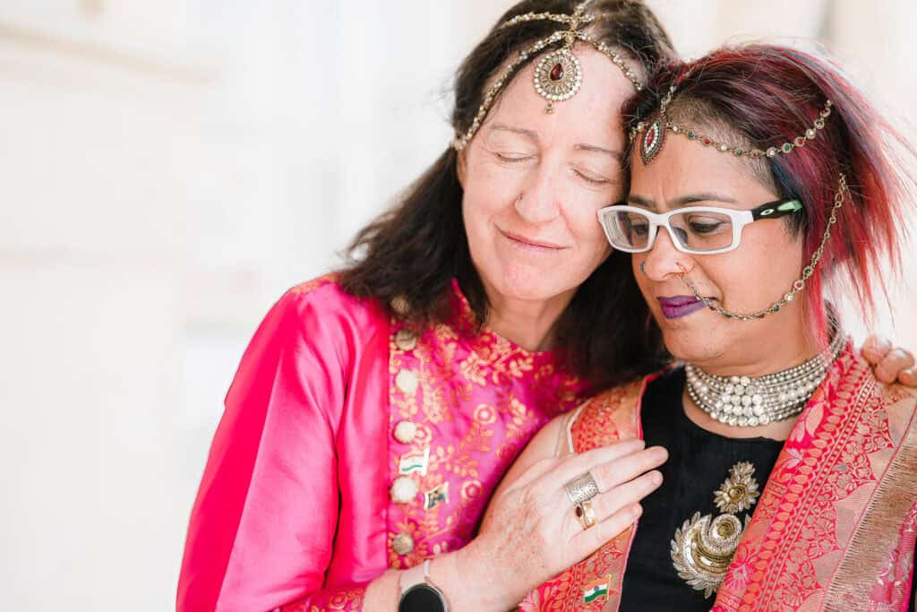 two women after their wedding in London looking peaceful as one places her hand on the other's shoulder